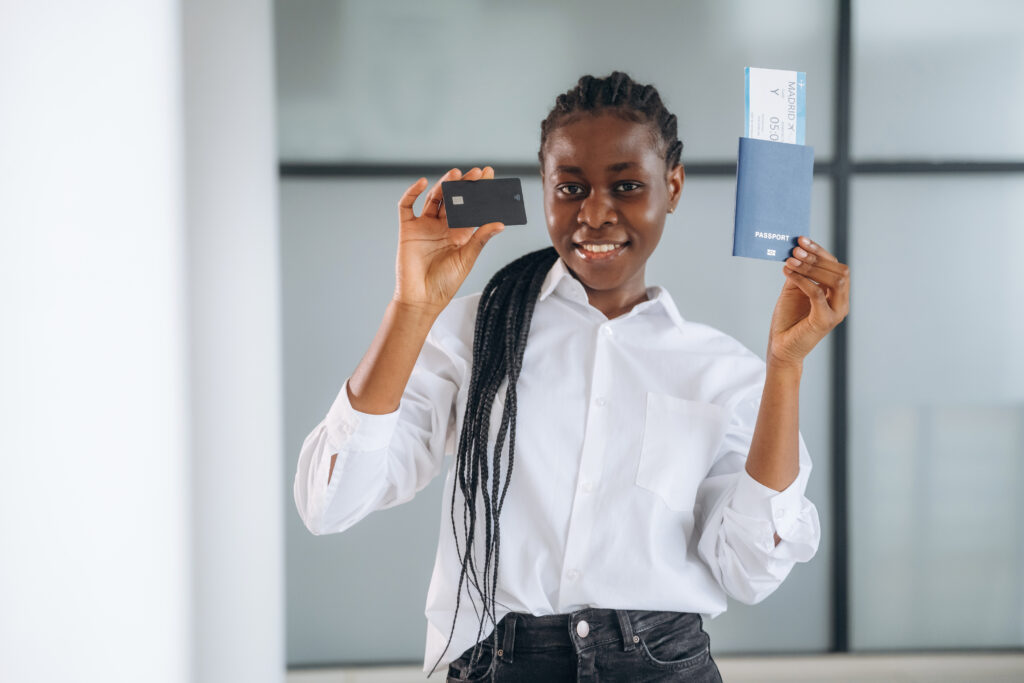 Vacation time, airport, with tickets. Businesswoman in formal clothes is in the modern room.